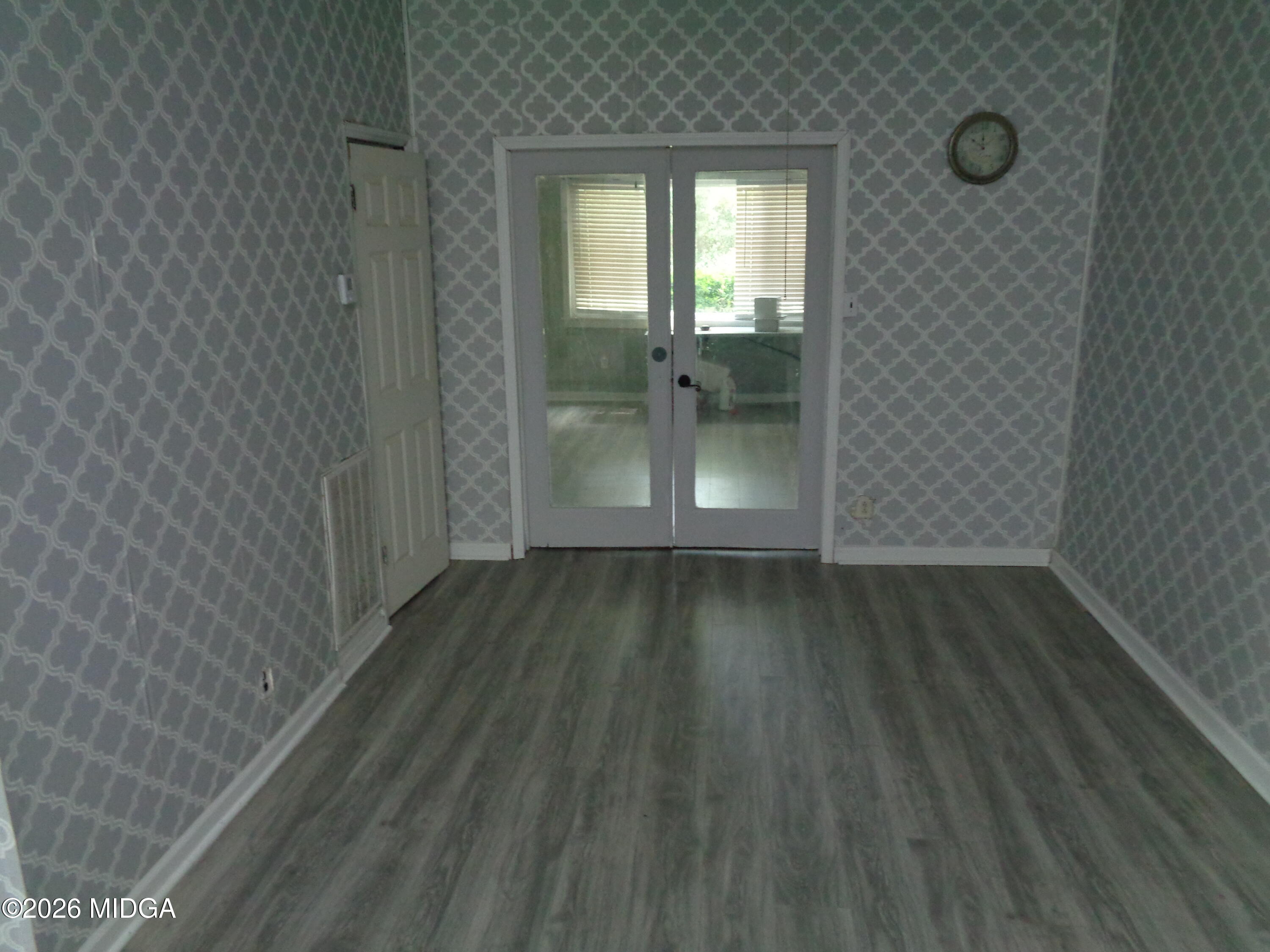 3380 Goodwin Lane Macon, GA 31217 - Photo 6 of 22 a view of a hallway with wooden floor and a living room