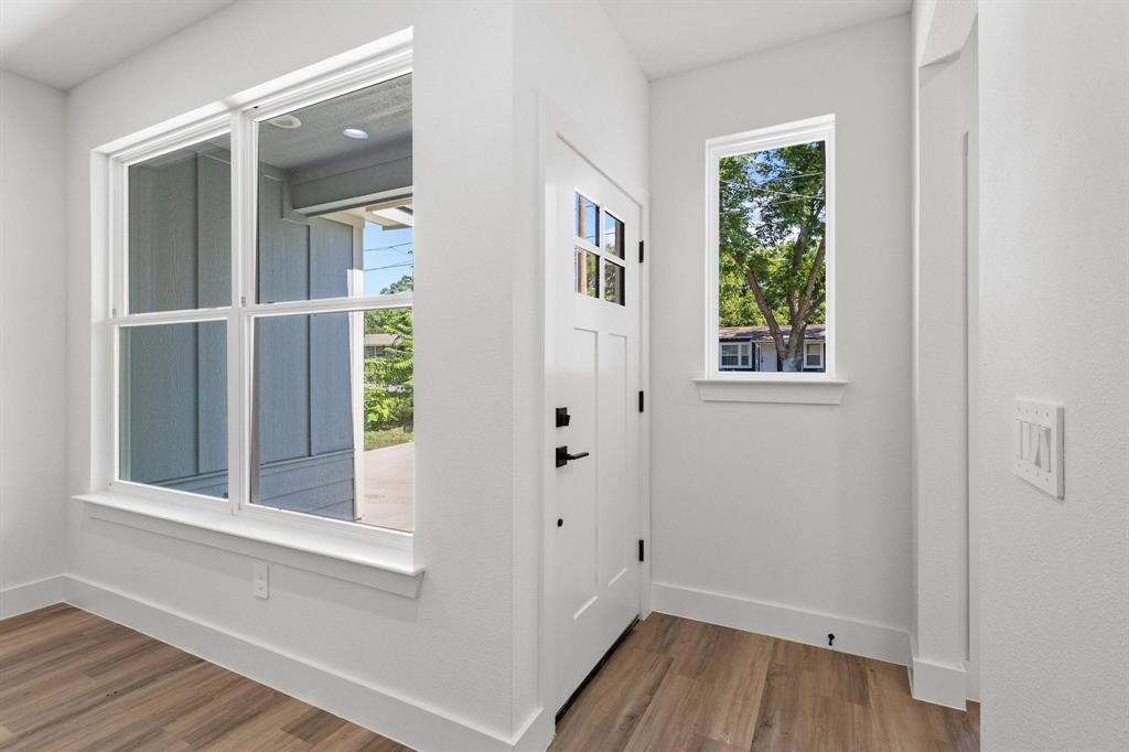 516 Florence Denison, TX 75020 - Photo 4 of 27 a view of an empty room with wooden floor and a window