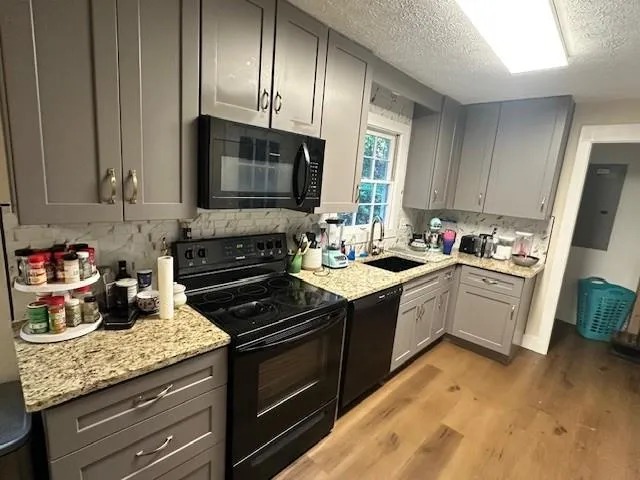 a kitchen with granite countertop wooden cabinets and a stove top oven