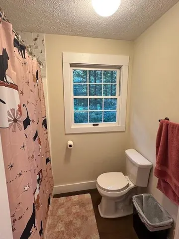 a white toilet sitting next to a bathroom sink