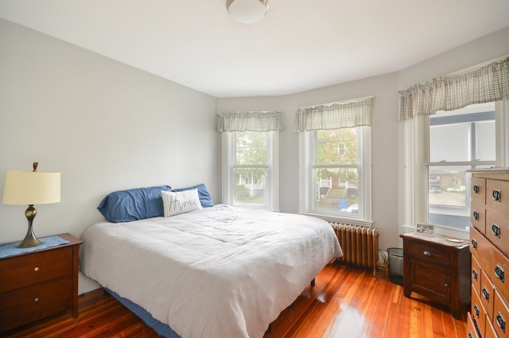 183 Cottage Park Road Winthrop, MA 02152 - Photo 11 of 35 a bedroom with a bed and a lamp with window