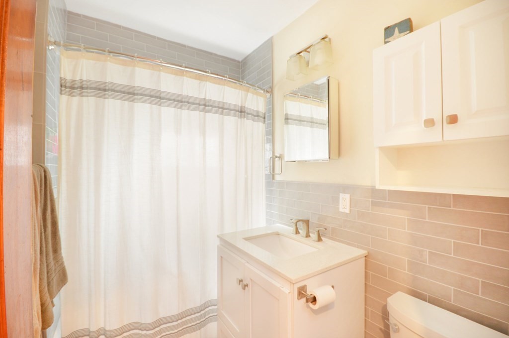 183 Cottage Park Road Winthrop, MA 02152 - Photo 12 of 35 a bathroom with a sink a toilet and a mirror