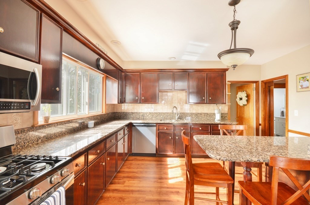 183 Cottage Park Road Winthrop, MA 02152 - Photo 19 of 35 a large kitchen with granite countertop lots of counter top space and stainless steel appliances