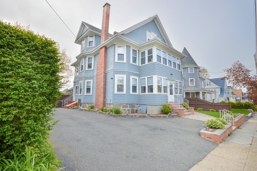 183 Cottage Park Road Winthrop, MA 02152 - Photo 2 of 35 a front view of a building with a garden and plants