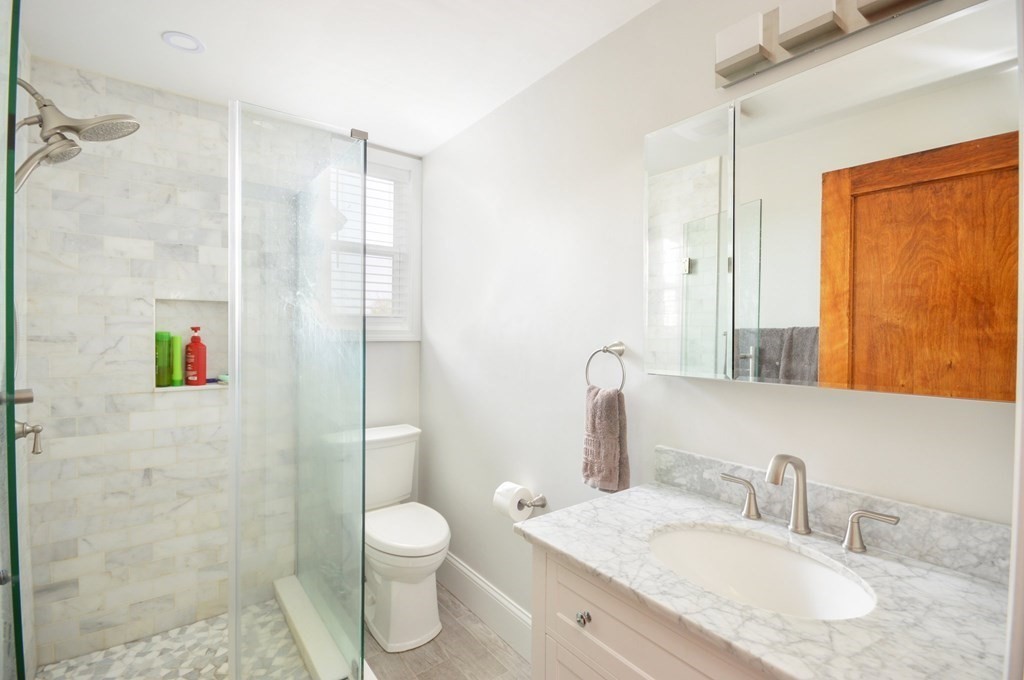 183 Cottage Park Road Winthrop, MA 02152 - Photo 21 of 35 a bathroom with a granite countertop sink toilet and shower