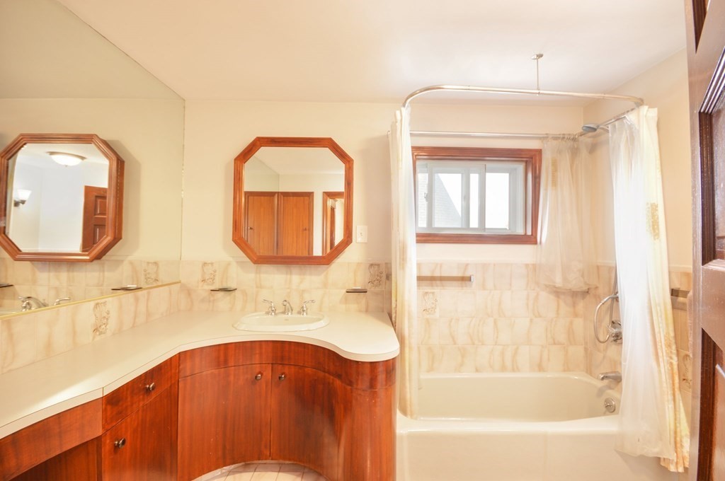 183 Cottage Park Road Winthrop, MA 02152 - Photo 25 of 35 a bathroom with a sink mirror and a bathtub