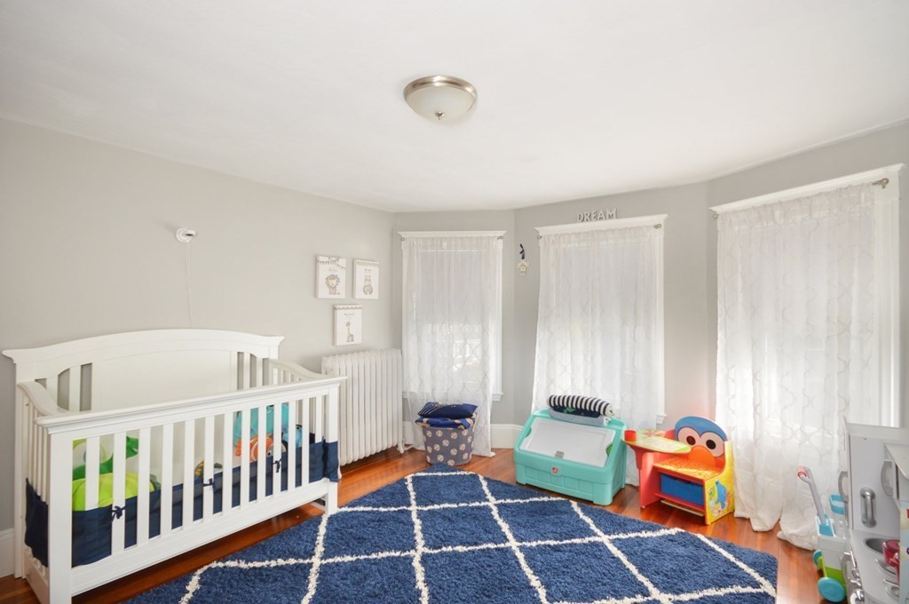 183 Cottage Park Road Winthrop, MA 02152 - Photo 28 of 35 a bedroom with furniture and wooden floor