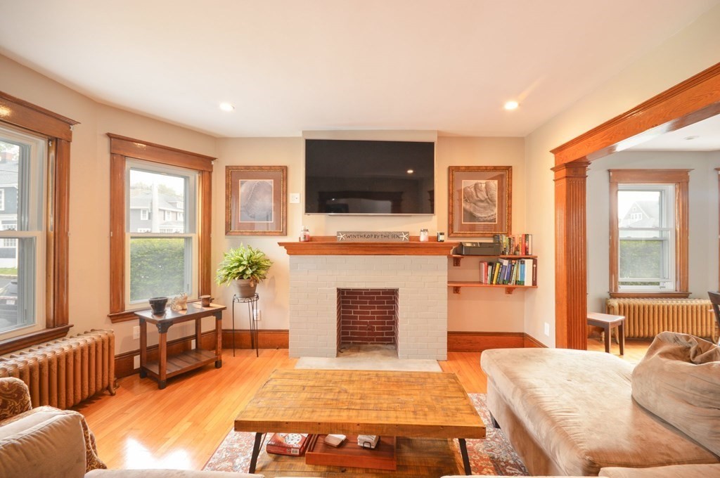 183 Cottage Park Road Winthrop, MA 02152 - Photo 5 of 35 a living room with furniture a flat screen tv and a fireplace