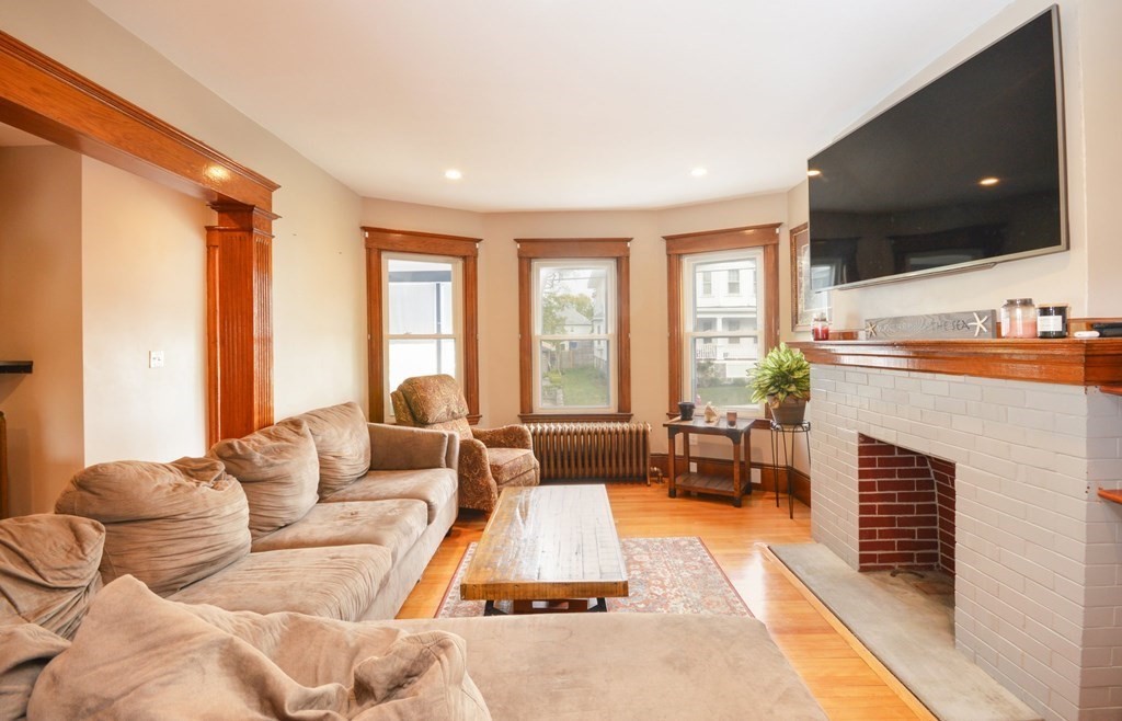 183 Cottage Park Road Winthrop, MA 02152 - Photo 6 of 35 a living room with fireplace furniture and a flat screen tv