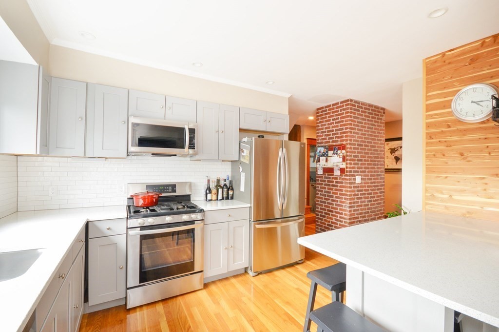 183 Cottage Park Road Winthrop, MA 02152 - Photo 9 of 35 a kitchen with stainless steel appliances a stove a sink and a refrigerator