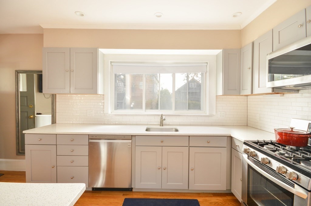183 Cottage Park Road Winthrop, MA 02152 - Photo 10 of 35 a kitchen with a sink stove and cabinets