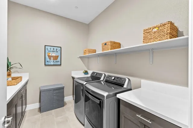 an aerial view of residential houses with outdoor space and parking