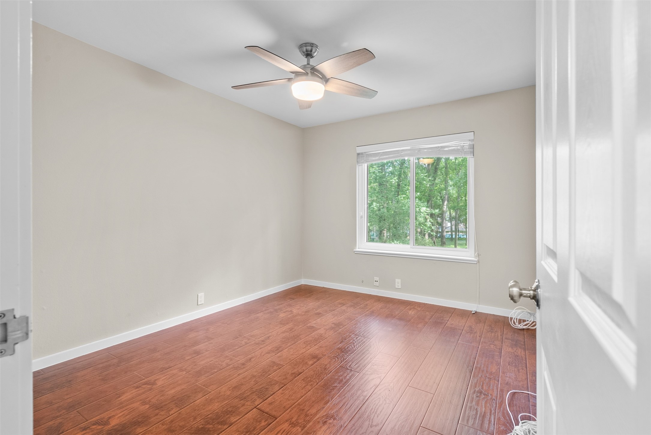 161 Litchfield Lane Houston, TX 77024 - Photo 19 of 30 an empty room with wooden floor and windows