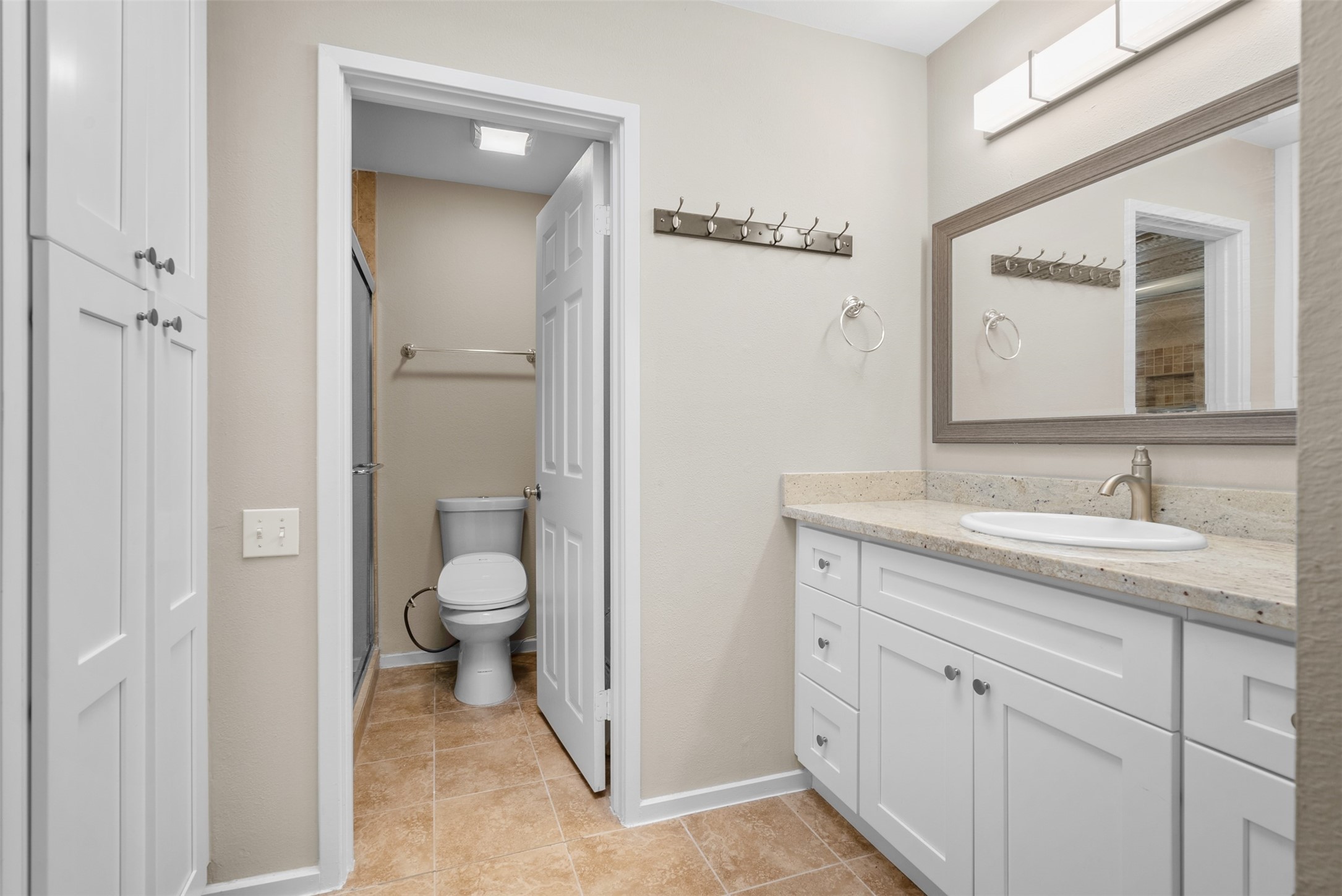 161 Litchfield Lane Houston, TX 77024 - Photo 21 of 30 a spacious bathroom with a granite countertop sink toilet and shower