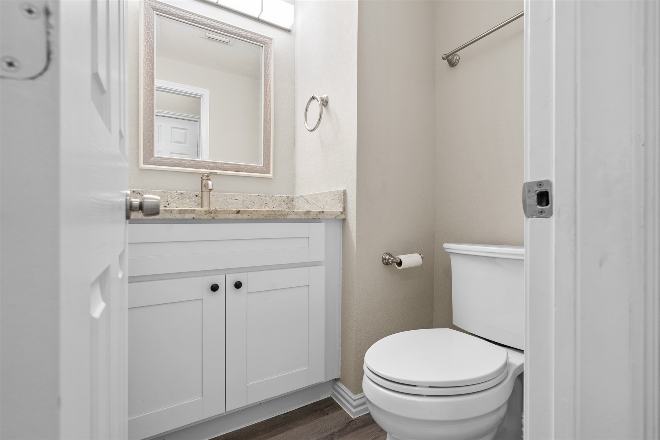 161 Litchfield Lane Houston, TX 77024 - Photo 23 of 30 a bathroom with a granite countertop toilet sink and mirror