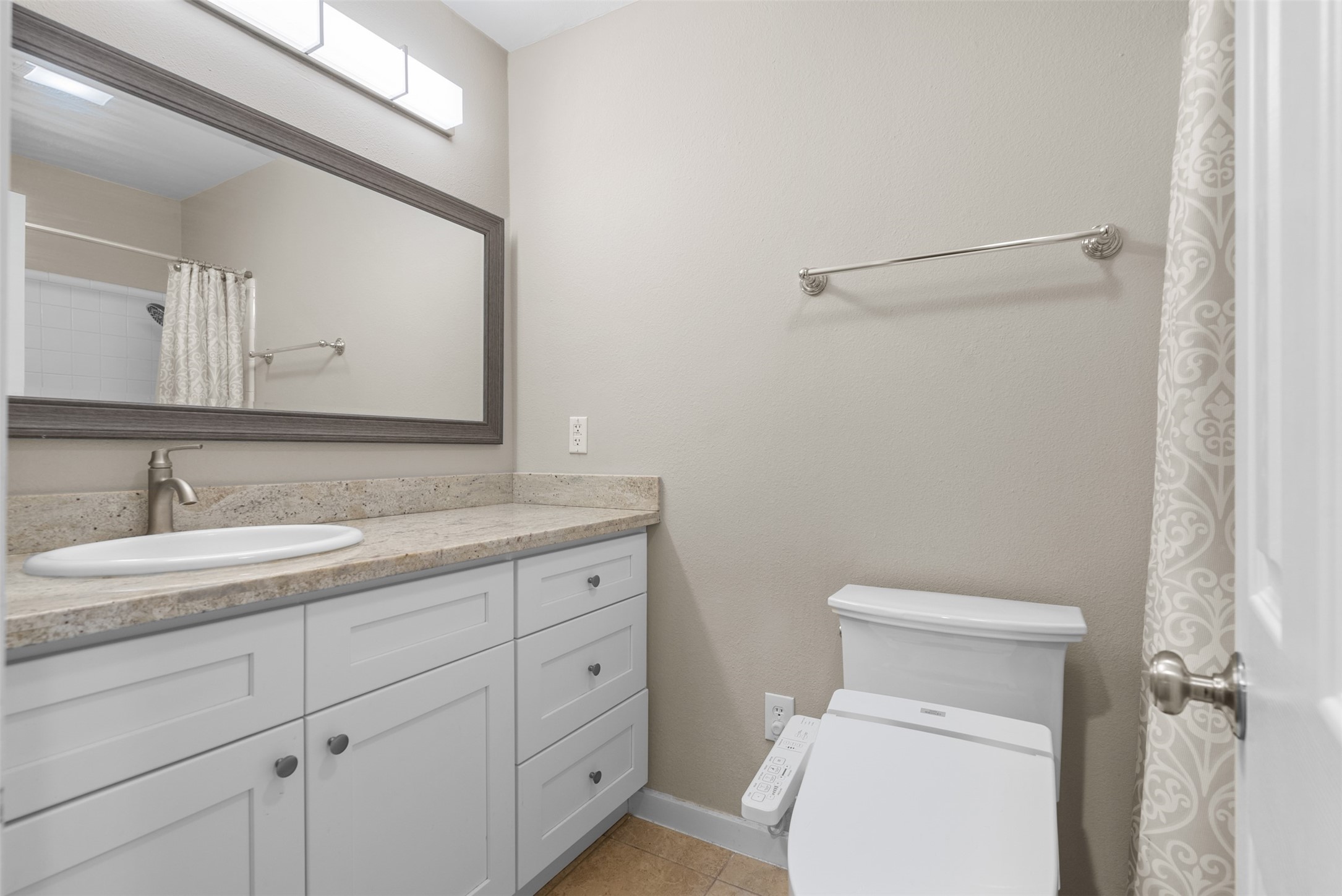 161 Litchfield Lane Houston, TX 77024 - Photo 25 of 30 a bathroom with a toilet sink and mirror