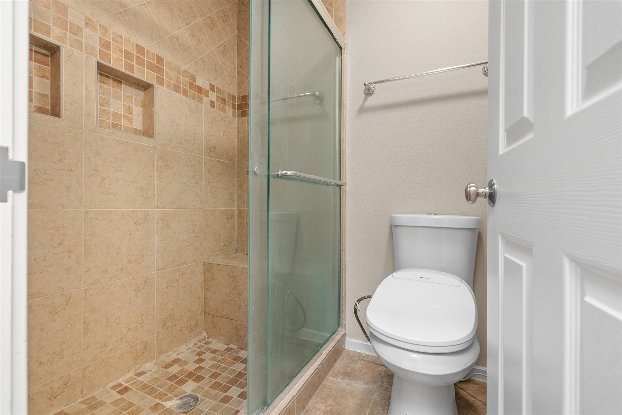 161 Litchfield Lane Houston, TX 77024 - Photo 27 of 30 a white toilet sitting next to a bathroom sink