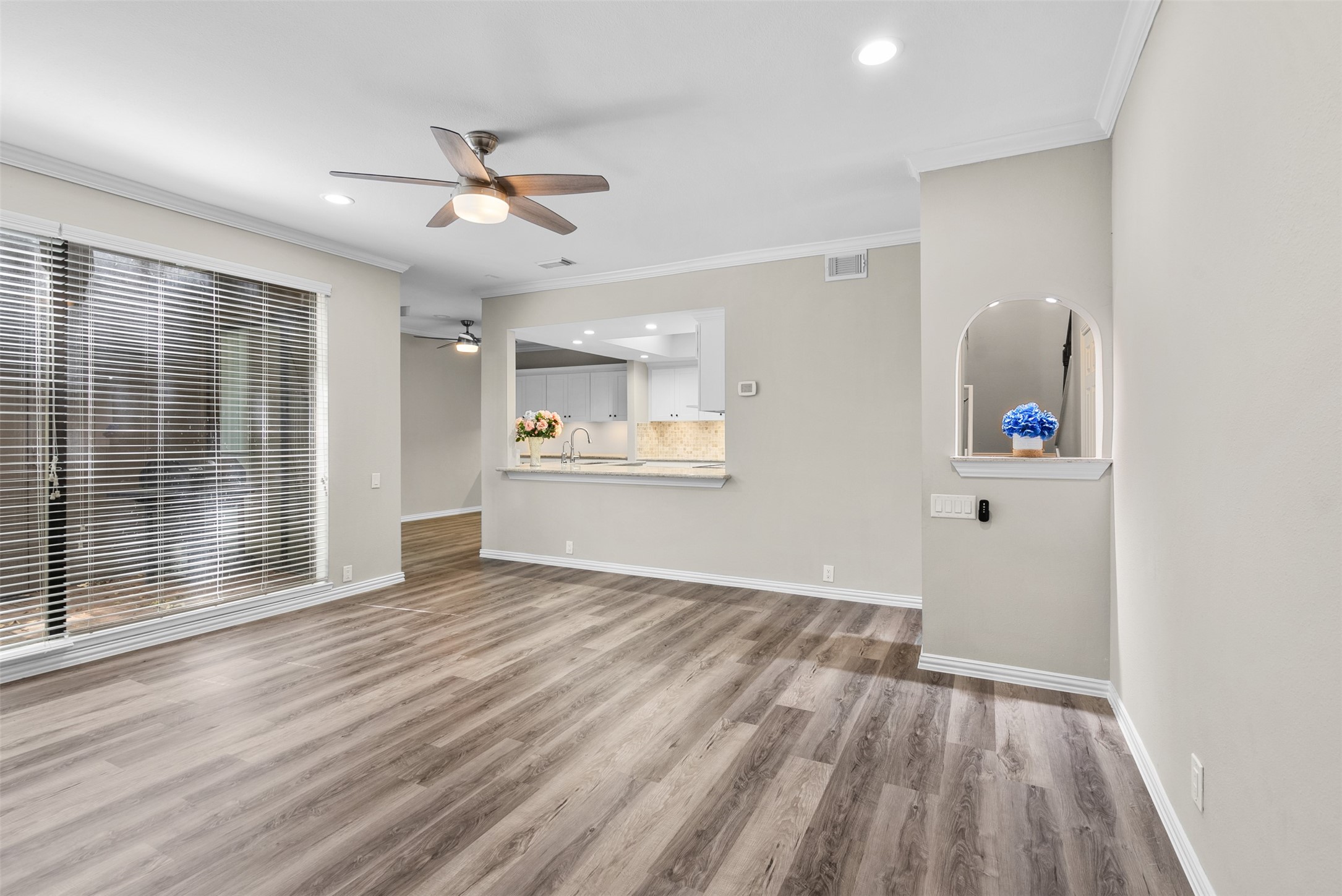 161 Litchfield Lane Houston, TX 77024 - Photo 6 of 30 an empty room with wooden floor and windows