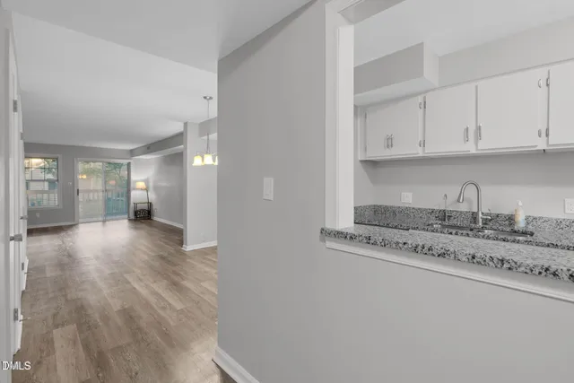 a view of a kitchen with granite countertop cabinets and wooden floor
