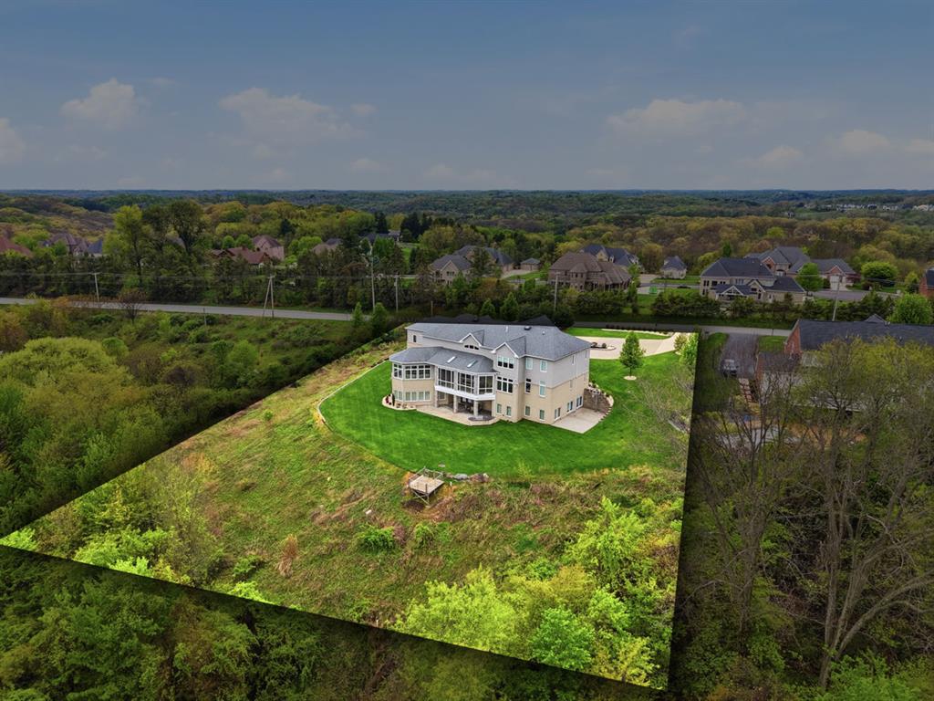 931 Pleasant Hill Road Wexford, PA 15090 - Photo 4 of 50 an aerial view of a house with a garden and lake view