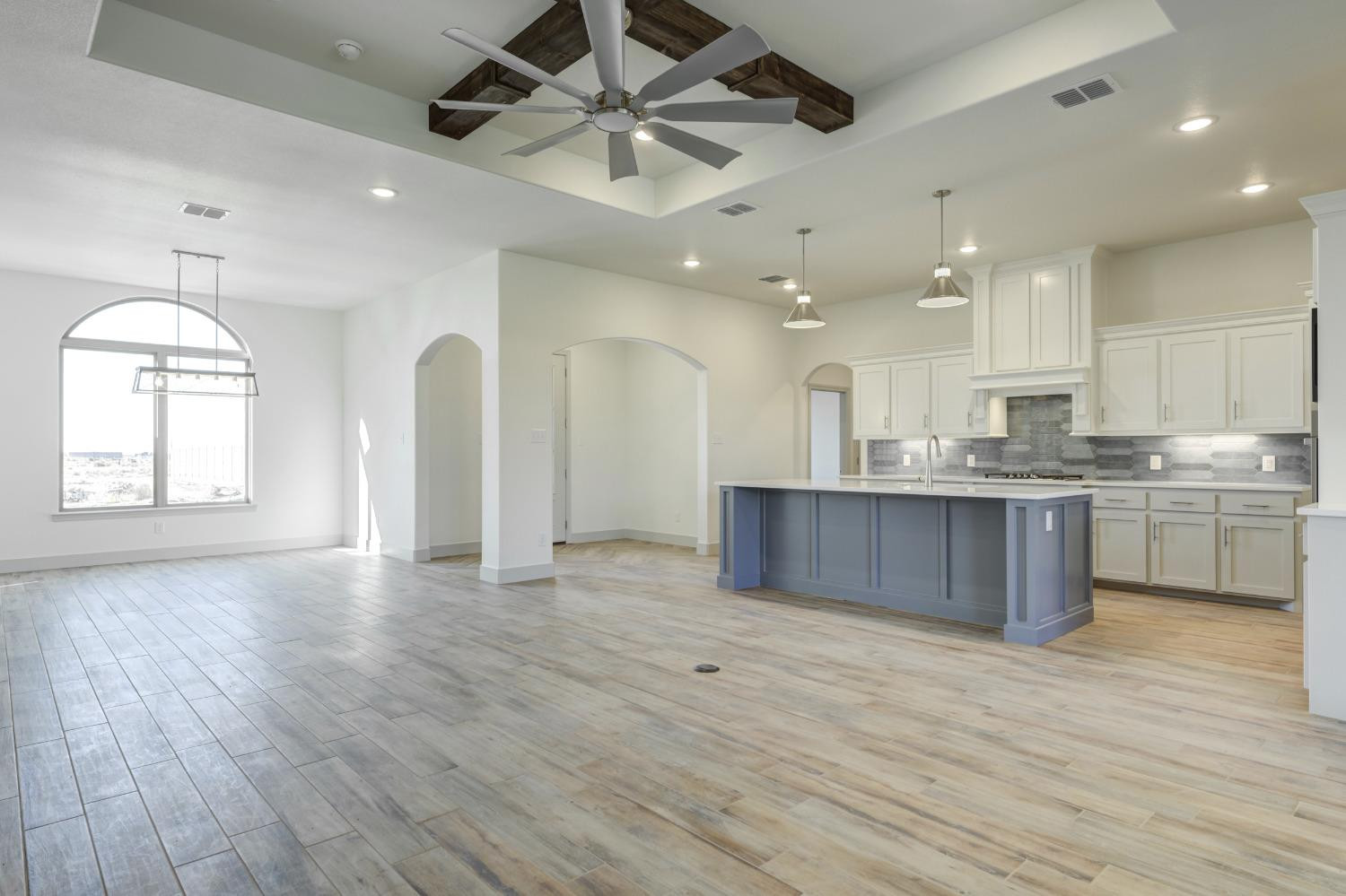 4608 140th Street Lubbock, TX 79424 - Photo 11 of 49 a large kitchen with stainless steel appliances granite countertop a large counter top a sink a refrigerator and a window