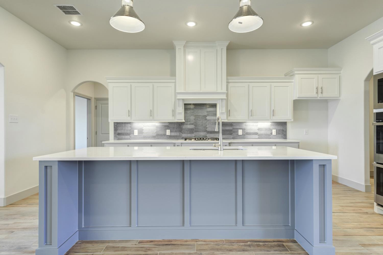 4608 140th Street Lubbock, TX 79424 - Photo 14 of 49 a kitchen with kitchen island granite countertop a sink and cabinets