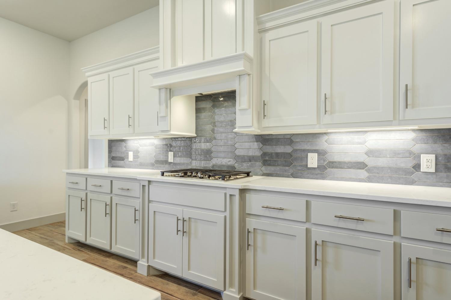 4608 140th Street Lubbock, TX 79424 - Photo 17 of 49 a kitchen with white cabinets and sink