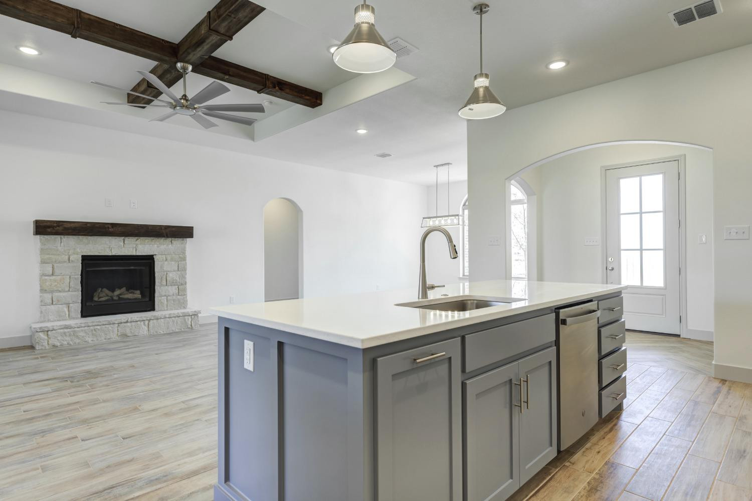 4608 140th Street Lubbock, TX 79424 - Photo 18 of 49 a kitchen with sink cabinets and wooden floor