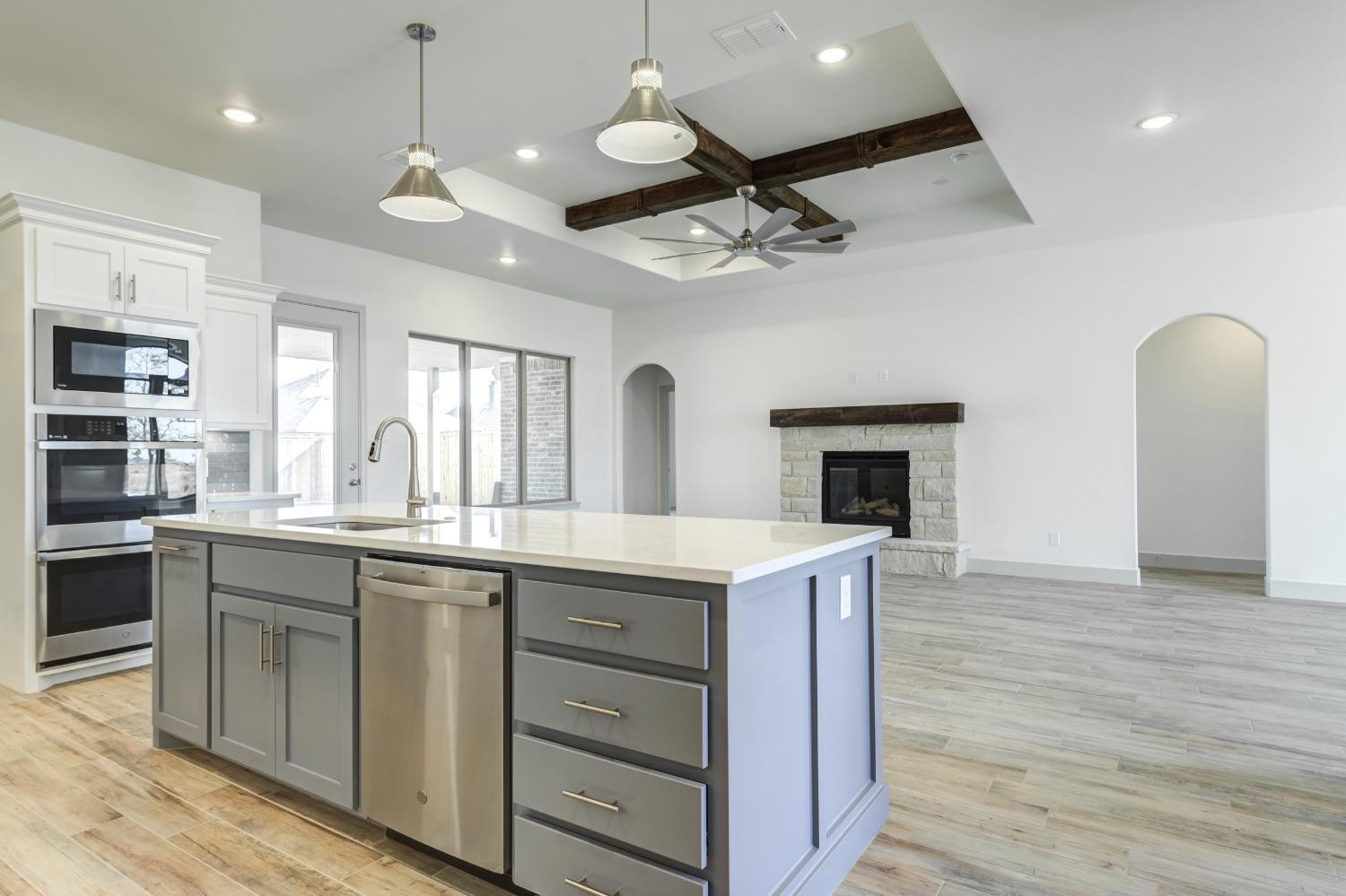 4608 140th Street Lubbock, TX 79424 - Photo 20 of 49 a kitchen with a sink cabinetry and wooden floor