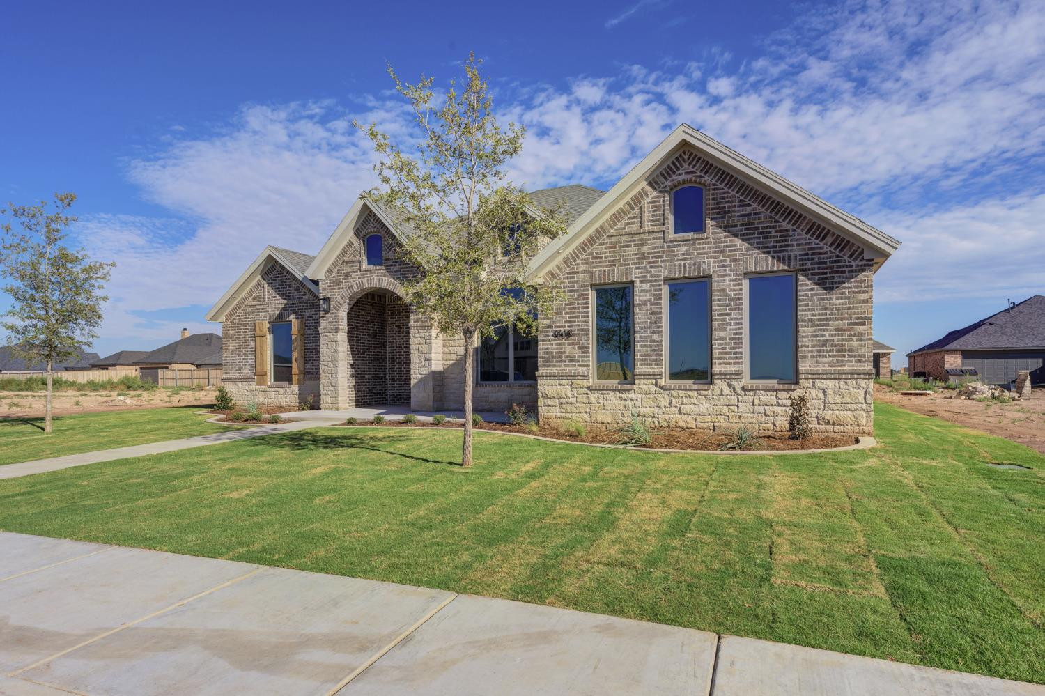 4608 140th Street Lubbock, TX 79424 - Photo 2 of 49 a front view of a house with a garden
