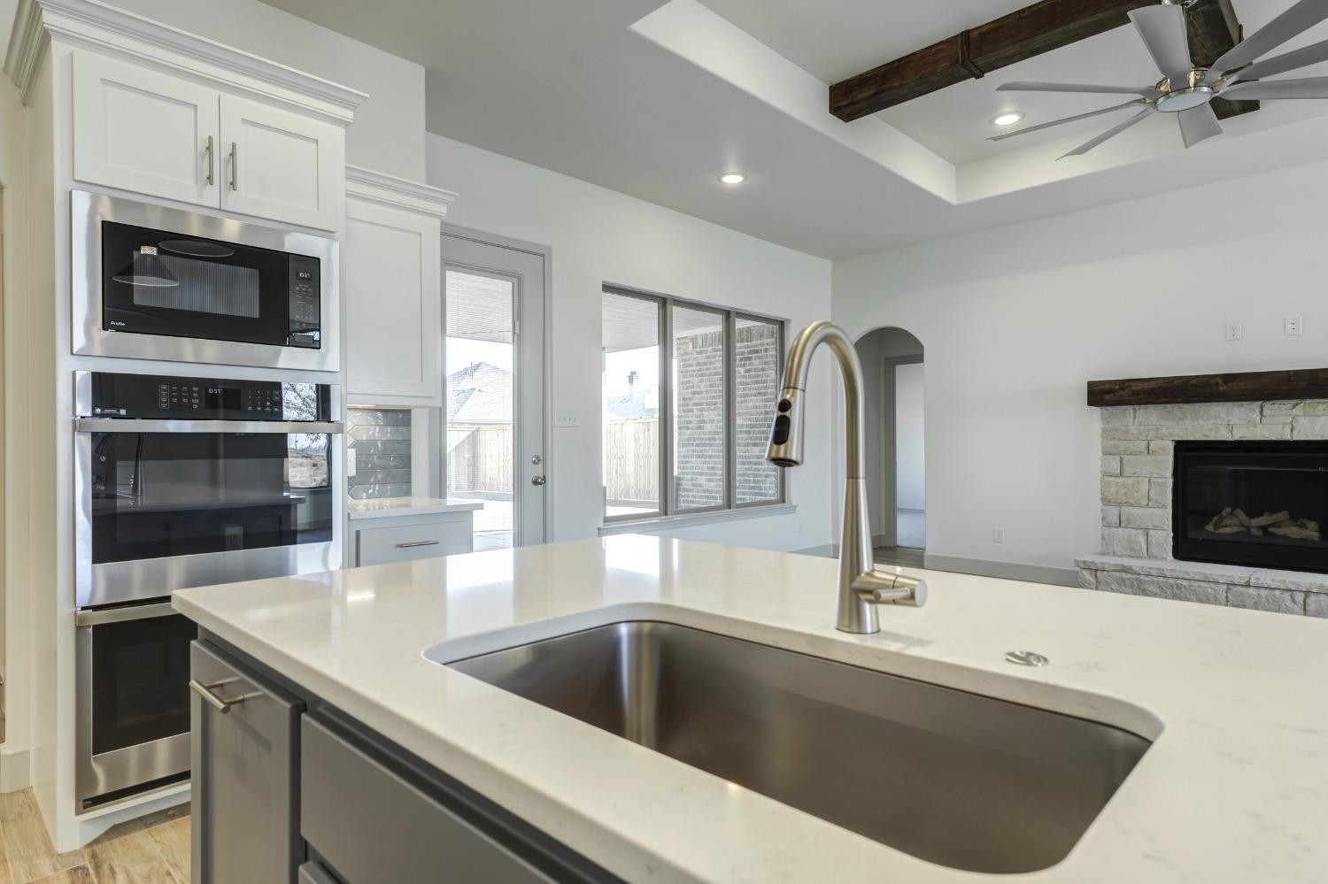 4608 140th Street Lubbock, TX 79424 - Photo 22 of 49 a kitchen with a sink and a microwave