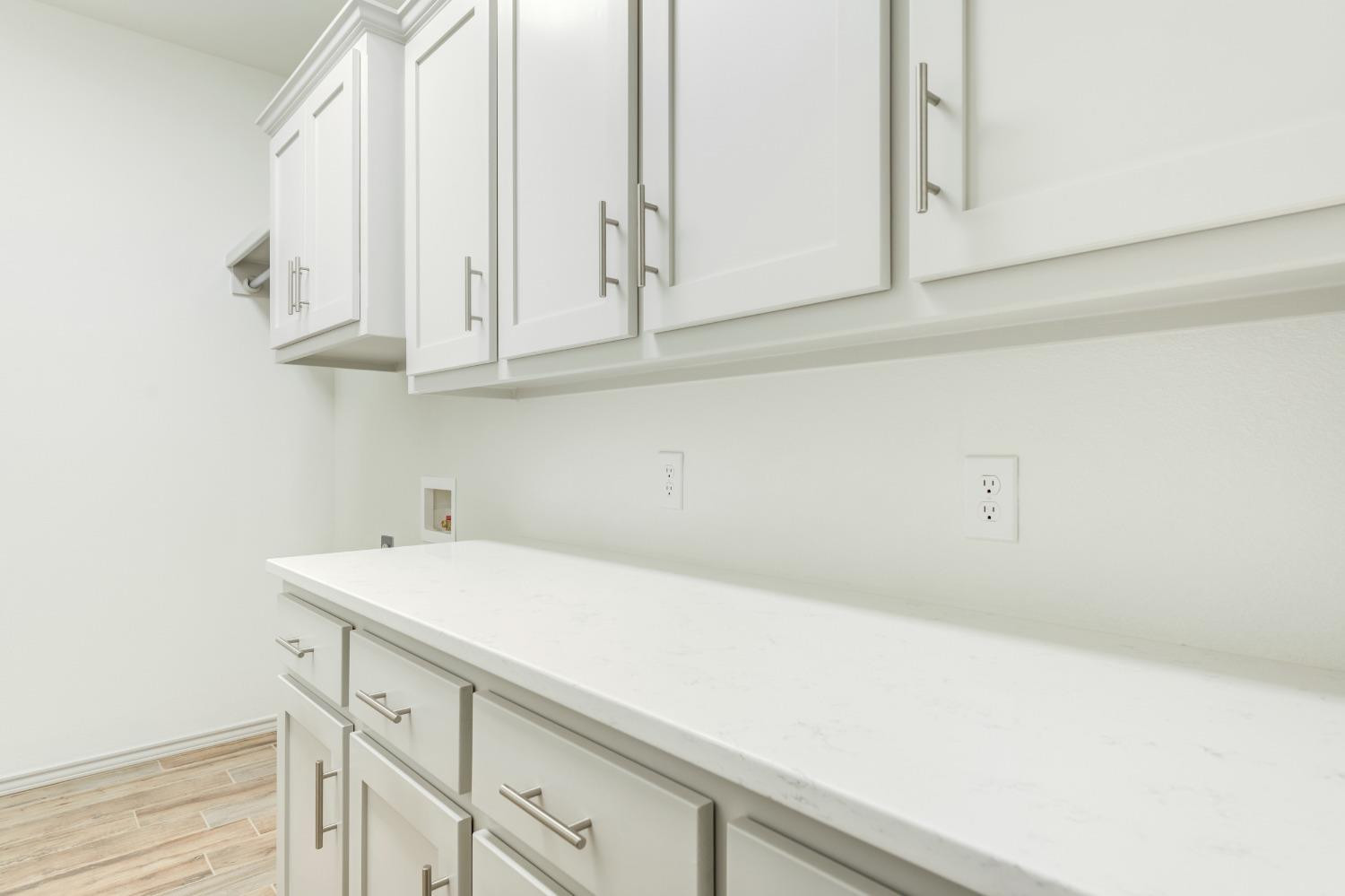 4608 140th Street Lubbock, TX 79424 - Photo 25 of 49 a view of cabinets with wooden floor