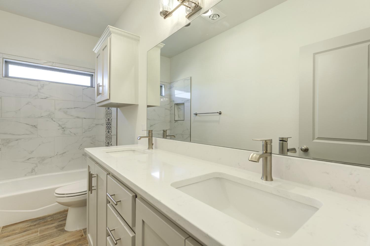 4608 140th Street Lubbock, TX 79424 - Photo 29 of 49 a bathroom with a sink a toilet and shower