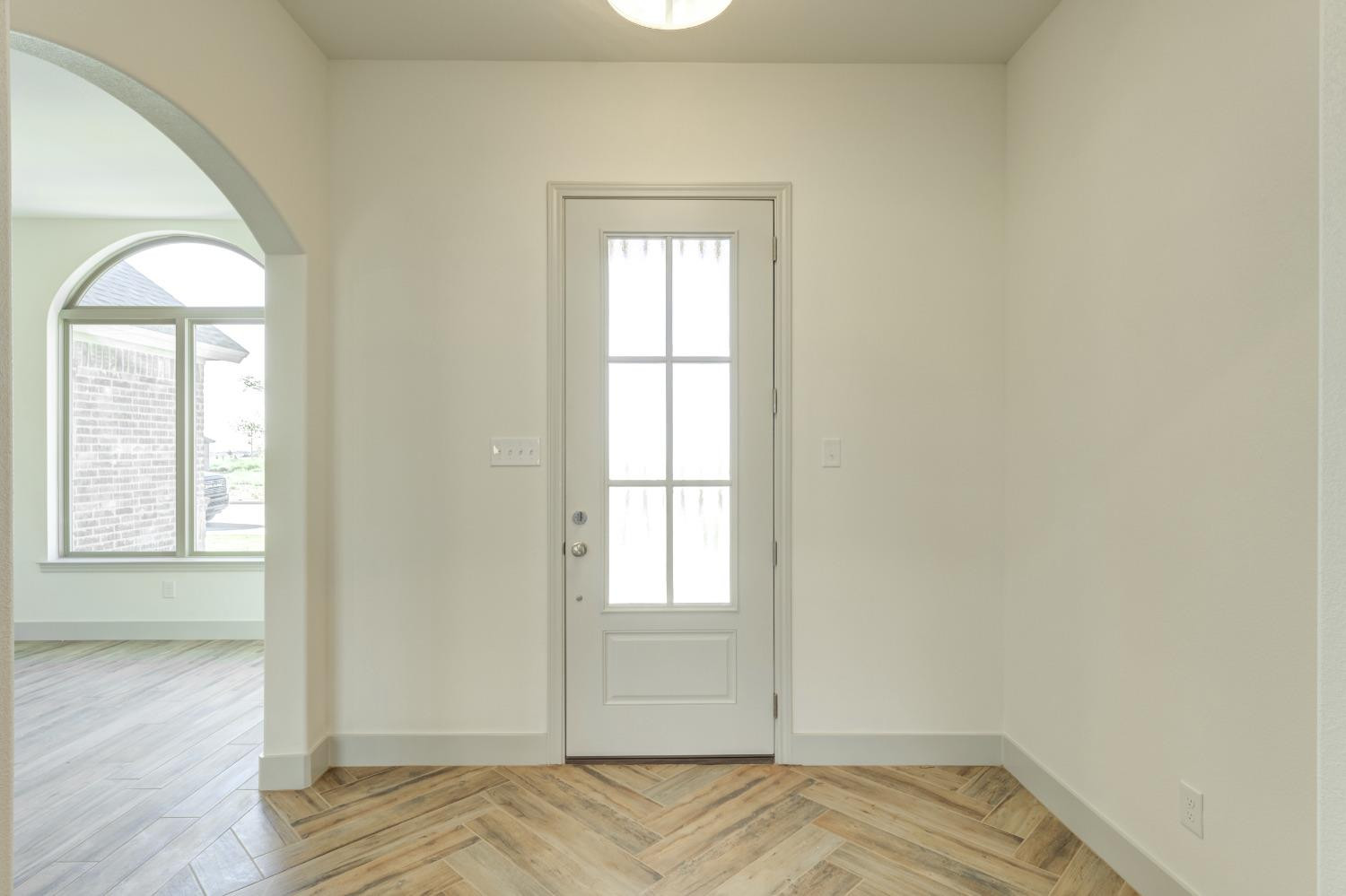 4608 140th Street Lubbock, TX 79424 - Photo 4 of 49 an empty room with wooden floor and windows