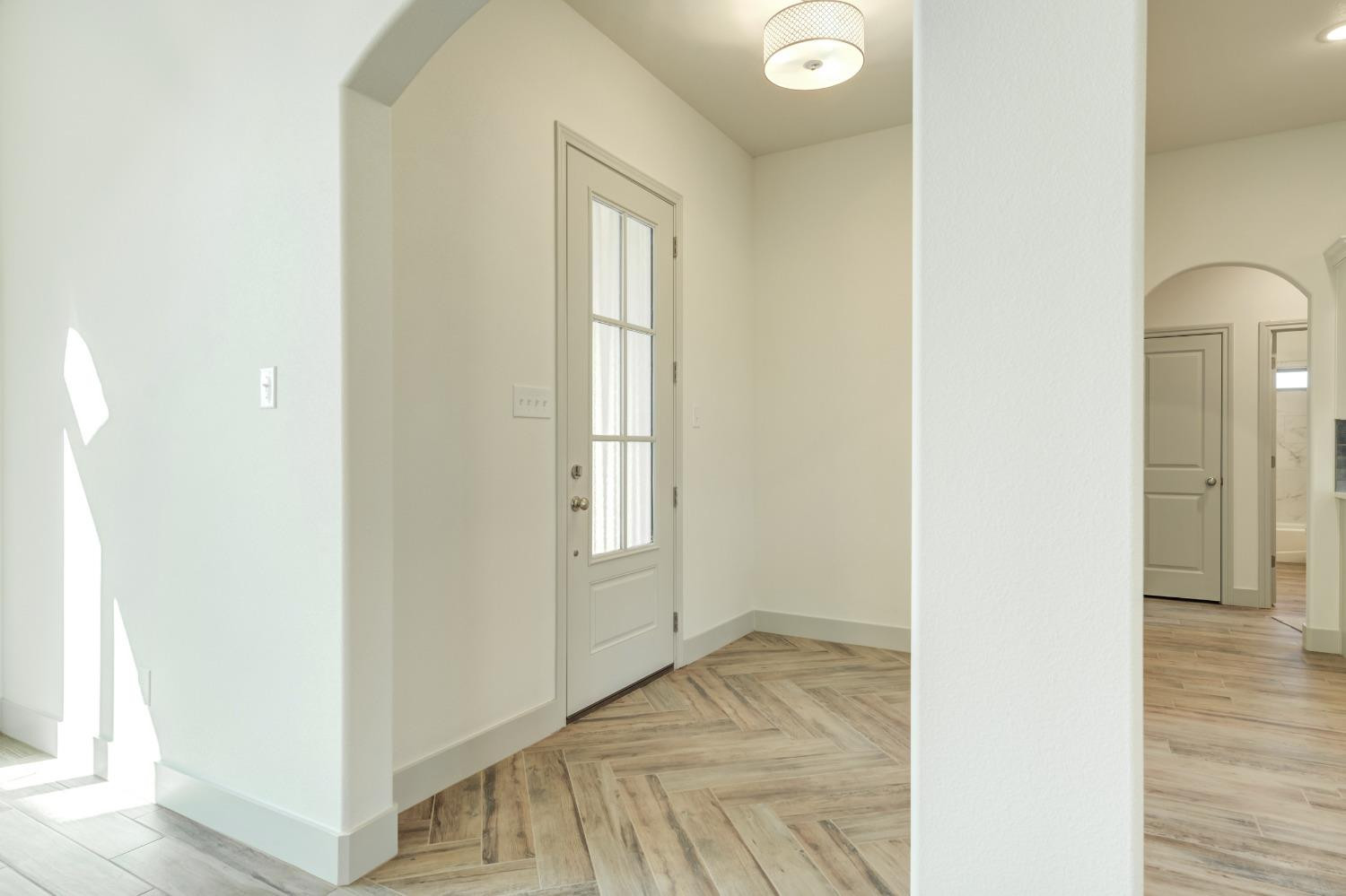 4608 140th Street Lubbock, TX 79424 - Photo 7 of 49 a view of a room that has a window and wooden floor