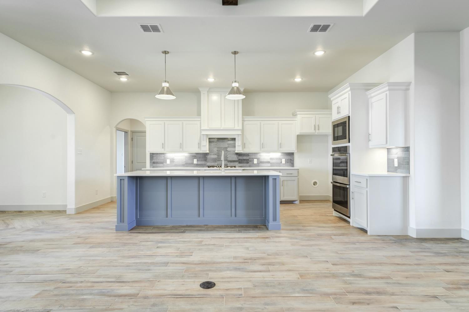 4608 140th Street Lubbock, TX 79424 - Photo 10 of 49 a large kitchen with kitchen island a sink stainless steel appliances and cabinets