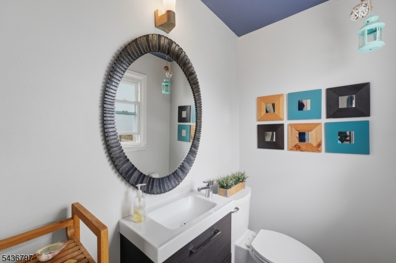 17 Arthur Drive Rutherford, NJ 07070 - Photo 19 of 45 a bathroom with a toilet sink and mirror