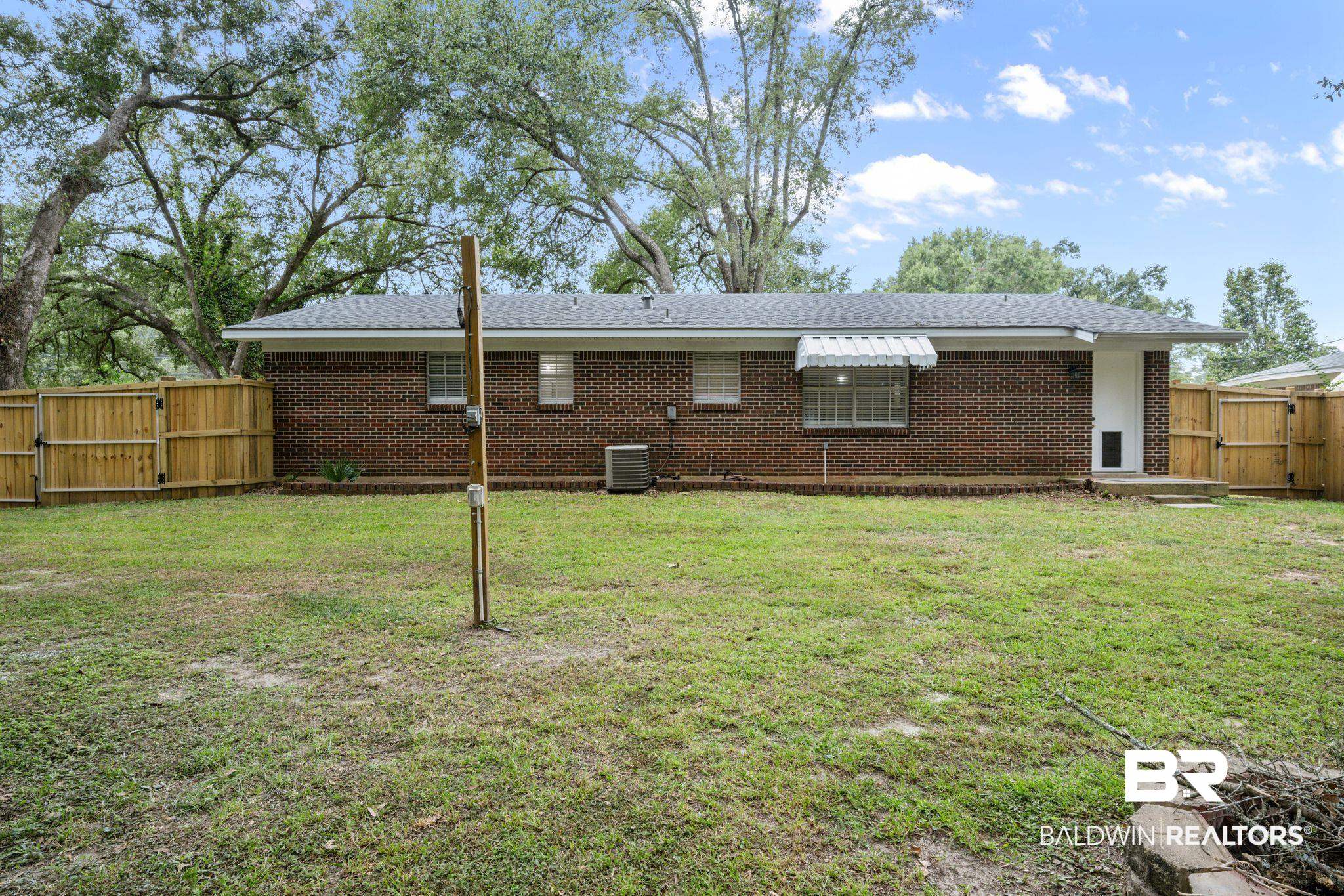 621 Ann Street Saraland, AL 36571 - Photo 19 of 21 Back of house with a lawn