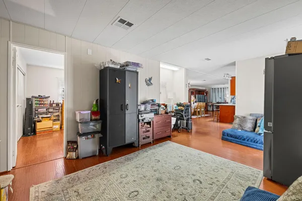 a living room with furniture and a wooden floor