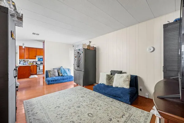 a bedroom with a bed and wooden floor