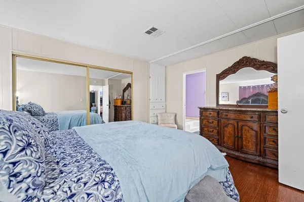 a bedroom with a bed and a dresser