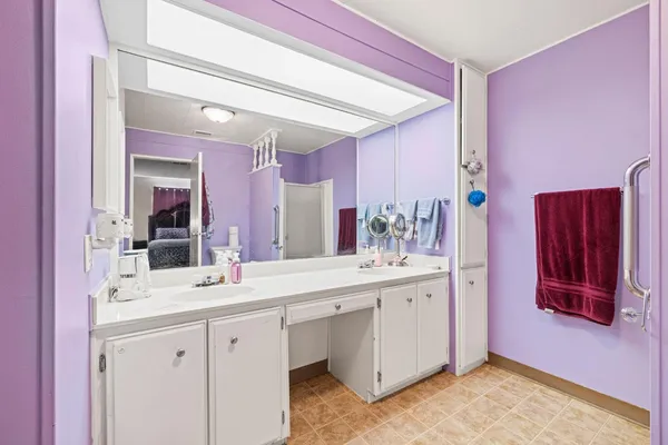 a bathroom with a sink vanity and mirror