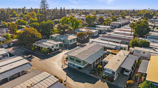 an aerial view of residential houses with city view