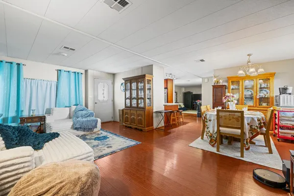 a living room with fireplace furniture and a large window