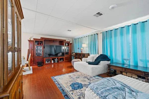 a bedroom with furniture and a flat screen tv