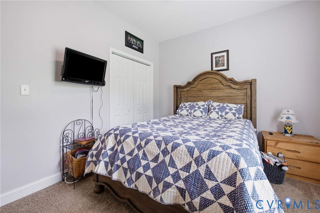9433 Robin Road Disputanta, VA 23842 - Photo 19 of 26 Neutral wall paint with textured carpeting