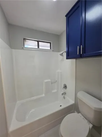 a bathroom with a toilet and a bathtub