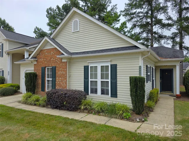 a view of a house with a yard and plants