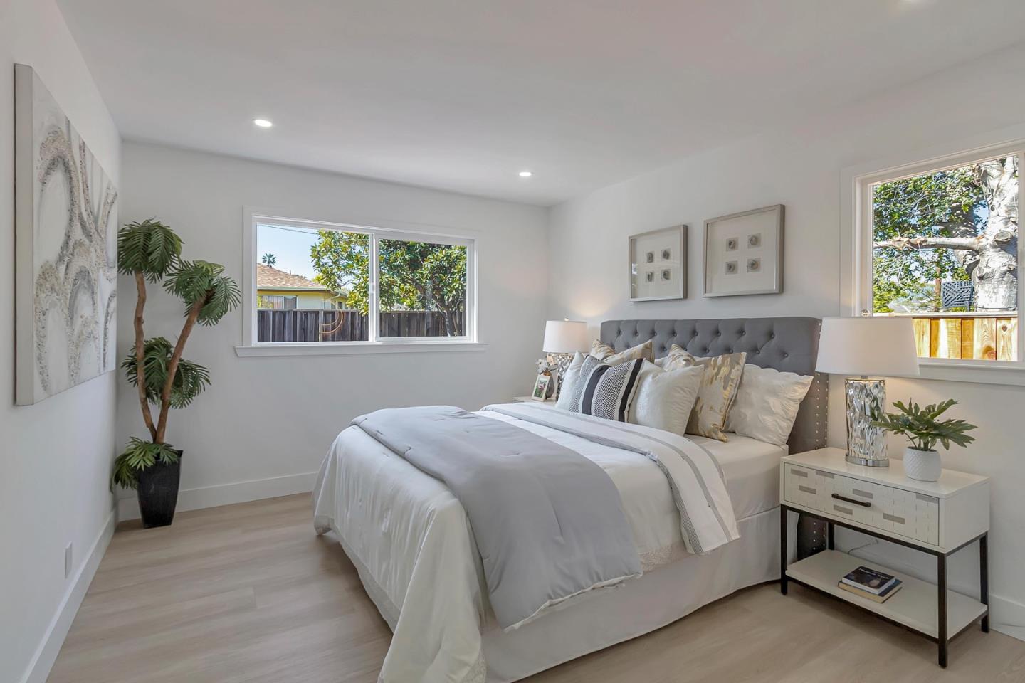 6722 Bollinger Road San Jose, CA 95129 - Photo 21 of 33 a bedroom with a large bed and a potted plant