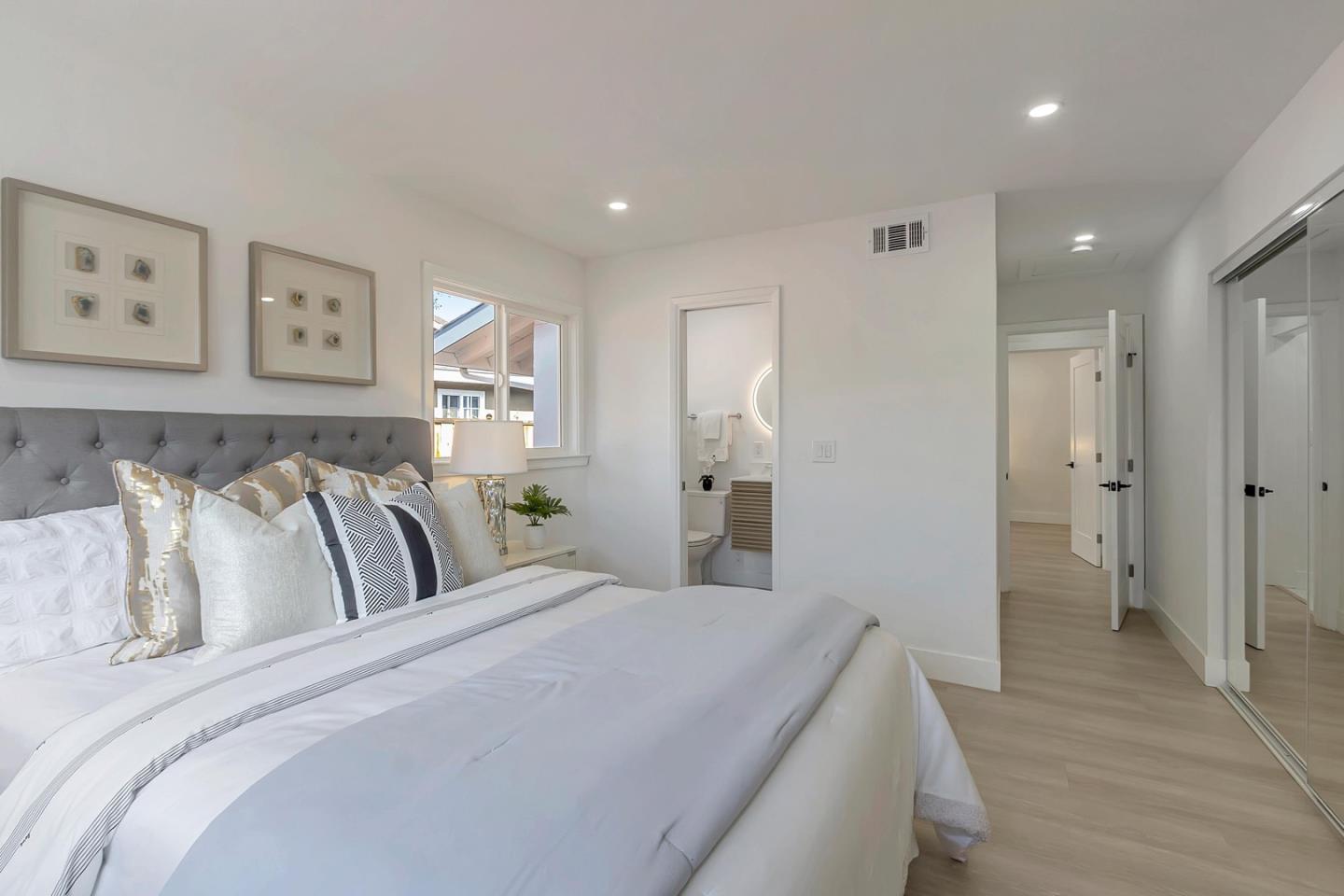 6722 Bollinger Road San Jose, CA 95129 - Photo 22 of 33 a spacious bedroom with a bed and painting on the wall